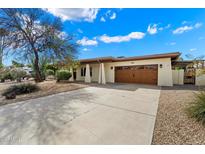 Charming single-story home with well-manicured landscaping and a spacious driveway at 6711 E Presidio Rd, Scottsdale, AZ 85254