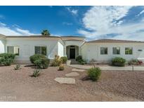 Charming single-story home with desert landscaping, a neutral color palette, and a welcoming front entrance at 9053 N 123Rd St, Scottsdale, AZ 85259