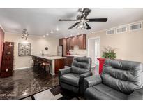 Open-concept living area with a kitchen, seating, and modern finishes at 1440 N Idaho Rd # 2053, Apache Junction, AZ 85119