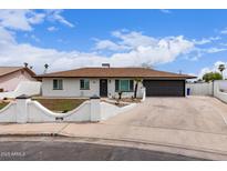 Charming single-story home features a manicured front yard, attached two-car garage, and inviting curb appeal at 1649 W Carmel Ave, Mesa, AZ 85202