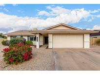 Charming single-story home with a two-car garage and colorful landscaping at 1825 S Spruce --, Mesa, AZ 85210