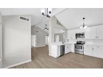Bright kitchen featuring white cabinets, stainless steel appliances, and modern fixtures at 2234 W Mohawk Ln, Phoenix, AZ 85027