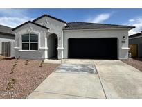 Charming single-story home featuring a two-car garage and low-maintenance desert landscaping at 25251 N 183Rd Dr, Wittmann, AZ 85361