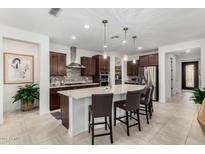 Modern kitchen with stainless steel appliances, a large island with seating, and pendant lighting at 3945 E Cherry Hills Dr, Chandler, AZ 85249