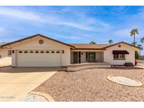 Charming single-story home with a two-car garage and well-maintained desert landscaping at 8011 E Milagro Ave, Mesa, AZ 85209