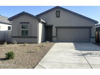 A charming single-story home with a well-manicured front yard and a two-car garage at 13193 E Verbina Ln, Florence, AZ 85132