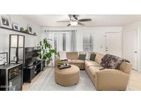 Inviting living room featuring a comfortable sectional sofa, stylish decor, and abundant natural light at 1645 W Baseline Rd # 2176, Mesa, AZ 85202