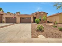 Beautiful single-story home with a three-car garage and desert landscaping for low maintenance at 16911 W Palm Ln, Goodyear, AZ 85395