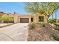 Charming single-story home with a two-car garage, desert landscaping, and a walkway to the front door at 16955 W Cypress St, Goodyear, AZ 85395