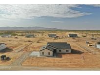 New construction homes in a rural desert community feature spacious lots and mountain views at 25875 W Running Deer Trl, Wittmann, AZ 85361