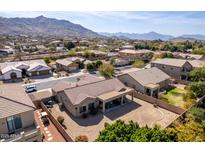 Stunning aerial view of the home with a covered patio, landscaped yard, and beautiful mountain views at 2612 W Summerside Rd, Phoenix, AZ 85041