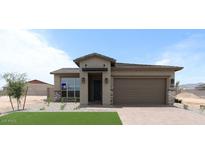 Charming single-story home with a two-car garage, desert landscaping and stone veneer accents at 5619 N 193Rd Ave, Litchfield Park, AZ 85340