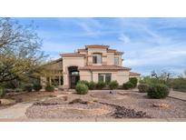 Stunning two-story home with a well-manicured front yard and desert landscaping under a blue sky at 6009 E Dale Ln, Cave Creek, AZ 85331