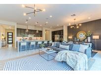 Open-concept living area featuring a comfortable sofa, modern kitchen, and seamless flow for entertaining at 7330 E Vista Bonita Dr, Scottsdale, AZ 85255