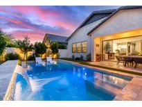 Beautiful backyard oasis featuring a sparkling pool and seamless indoor/outdoor lifestyle at 851 E Deer Creek Rd, Phoenix, AZ 85048