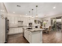 Bright kitchen features a large island, stainless steel appliances, and adjacent dining area at 10260 E White Feather Ln # 1022, Scottsdale, AZ 85262