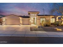 Stunning home featuring a well-manicured yard and three-car garage with custom stone accents at 11339 E Beck Ln, Scottsdale, AZ 85255