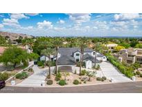 A stunning exterior elevation showcases a grand home with meticulous landscaping and a porte cochere at 11827 S Montezuma Ct, Phoenix, AZ 85044