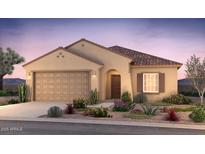 Charming single-story home featuring a tile roof, desert landscaping, and a two-car garage at 17764 W Getty Dr, Goodyear, AZ 85338