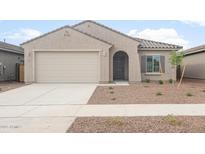 Single-story home featuring a neutral color palette, tiled roof, and attached two-car garage at 17764 W Getty Dr, Goodyear, AZ 85338