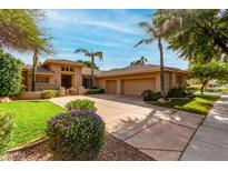 Charming single-story home with a well-manicured lawn, mature landscaping, and a spacious three-car garage at 1833 W Mead Pl, Chandler, AZ 85248