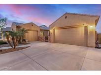 Stunning home exterior featuring attached garages, desert landscaping, and a stone courtyard entrance at 1916 E Dubois Ave, Gilbert, AZ 85298