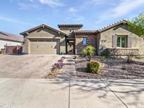 Charming single-Gathering home featuring a two-car garage, stone accents, and desert landscaping at 20075 E Kestrel St, Queen Creek, AZ 85142
