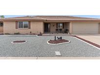 Charming single-story home featuring desert landscaping, a covered porch, and attached two-car garage at 8315 E Lobo Ave, Mesa, AZ 85209