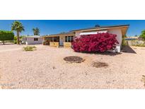 Charming single-story home featuring desert landscaping, a vibrant bougainvillea, and a clear blue sky at 5410 E Duncan St, Mesa, AZ 85205