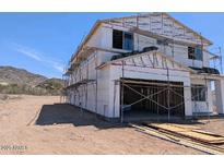 Exterior view of a two-story home in the process of being built showing windows, garage, and partial roof at 3835 W Fox Rd, Laveen, AZ 85339