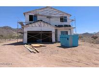 Exterior of a two-story home under construction, showing an attached garage, windows, and a partly finished roof at 3835 W Fox Rd, Laveen, AZ 85339