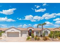 Inviting single-story home featuring a desert landscape, tile roof and attached two-car garage at 7722 E Hartford Dr, Scottsdale, AZ 85255