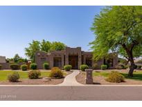 Stunning single-story home featuring lush landscaping and desert-style architecture, creating a welcoming curb appeal at 19515 E Via Del Palo --, Queen Creek, AZ 85142