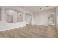 Open-concept living room featuring decorative columns and light wood flooring at 1112 E Winged Foot Dr, Chandler, AZ 85249