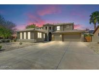 Stunning two-story home with a three-car garage and desert landscaping at 15138 W Campbell Ave, Goodyear, AZ 85395