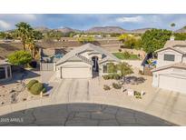 Charming home with desert landscaping, mountain views and a two car garage at 20017 N 65Th Dr, Glendale, AZ 85308
