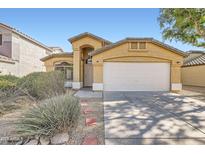 Charming single-Gathering home featuring a two-car garage and well-maintained front yard landscaping at 12333 W Marshall Ave, Litchfield Park, AZ 85340