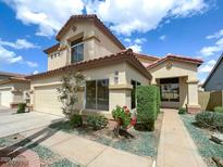 Beautiful two-story home featuring a well-maintained lawn and inviting curb appeal under a bright, sunny sky at 1360 E Washington Ave, Gilbert, AZ 85234