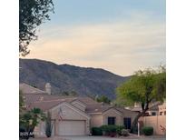 Charming single-Gathering home featuring a two-car garage and desert landscaping with mountain views at 1620 W Nighthawk Way, Phoenix, AZ 85045