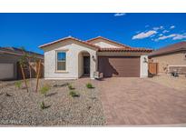 Charming single-story home features a tile roof, brick-paved driveway, two-car garage, and drought-resistant landscaping at 18508 E Dario Rd, Gold Canyon, AZ 85118
