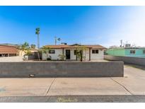Charming single-story home with a new concrete brick wall and palm trees at 2019 W Wayland Rd, Phoenix, AZ 85041