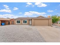 Charming single-story home with a two car garage and low maintenance gravel landscaping at 2741 E Sweetwater Ave, Phoenix, AZ 85032