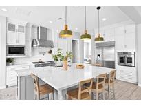 Bright kitchen with stainless steel appliances, white cabinetry, and a large island at 3842 E Fountain St, Mesa, AZ 85205