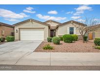 Charming single-story home featuring a two-car garage and low maintenance desert landscaping in the front yard at 4148 W Dayflower Dr, San Tan Valley, AZ 85144