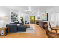 Bright living room with wood floors, a fireplace, and contemporary decor, flowing into an open-concept layout at 5104 N 32Nd St # 311, Phoenix, AZ 85018