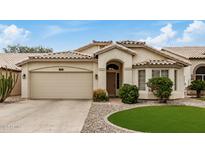 Charming single-story home featuring a well-manicured landscape and a welcoming entrance, complemented by a two-car garage at 628 N El Dorado Dr, Gilbert, AZ 85233
