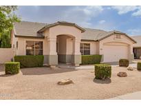 Charming single-story home with a well-manicured yard and a covered front entrance at 7839 E Osage Ave, Mesa, AZ 85212