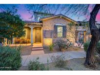 Beautiful brick home with a well-manicured front yard, desert landscaping, and a covered porch at 9439 E Trailside Vw, Scottsdale, AZ 85255