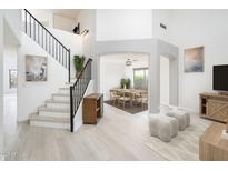 Inviting foyer showcasing a staircase with metal railings, an art niche, and easy access to the dining room at 10219 E Le Marche Dr, Scottsdale, AZ 85255