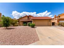 Charming single-story home featuring a red tile roof, neutral stucco, and low-maintenance landscaping at 12436 S 38Th Pl, Phoenix, AZ 85044
